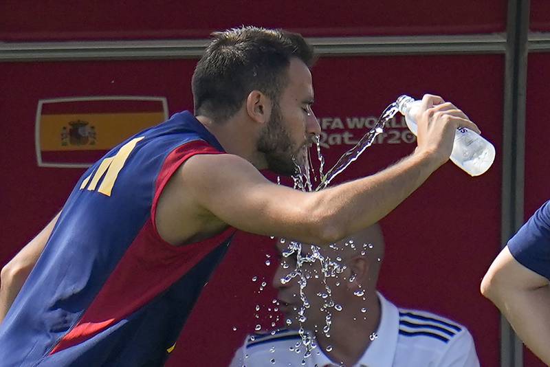 Spain's Eric Garcia douses himself with water. AP Photo