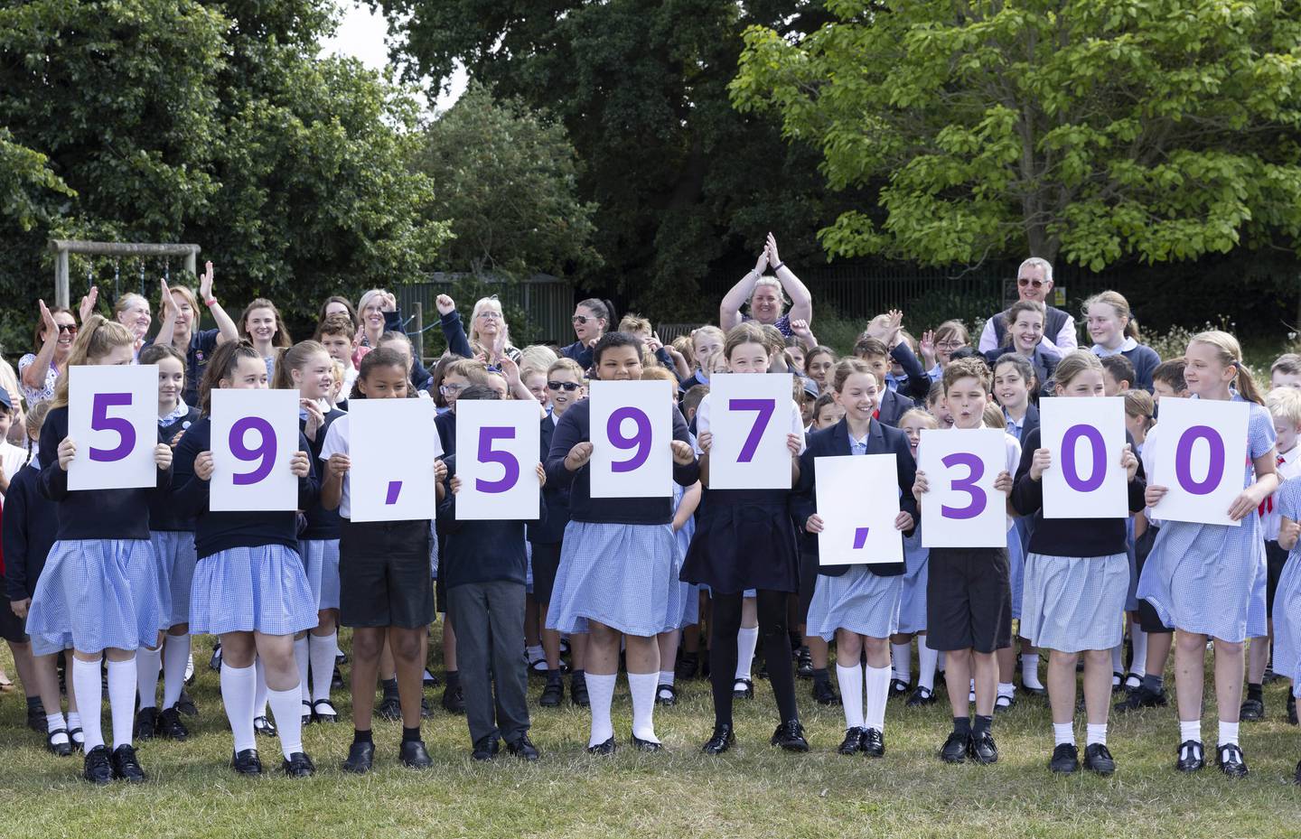 Schoolchildren show off the population of England and Wales for the 2021 census. PA
