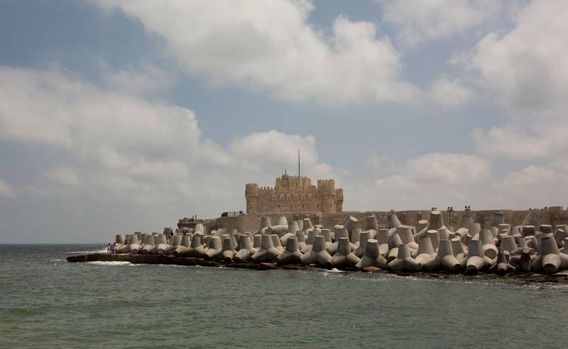 In this Aug. 8, 2019 photo, cement barriers reinforce the sea wall near the citadel in Alexandria, Egypt. Alexandria, which has survived invasions, fires and earthquakes since it was founded by Alexander the Great more than 2,000 years ago, now faces a new menace from climate change. Rising sea levels threaten to inundate poorer neighborhoods and archaeological sites, prompting authorities to erect concrete barriers out at sea to hold back the surging waves. (AP Photo/Maya Alleruzzo)