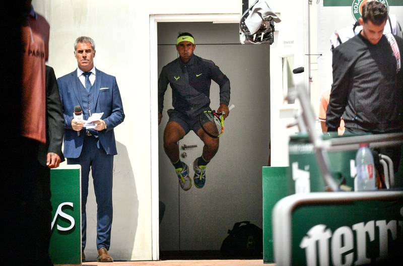 Nadal jumps and warms up before entering the tennis court. AFP