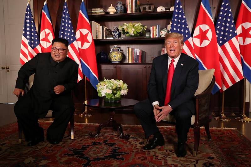 U.S. President Donald Trump sits next to North Korea's leader Kim Jong Un before their bilateral meeting at the Capella Hotel on Sentosa island in Singapore June 12, 2018. REUTERS/Jonathan Ernst