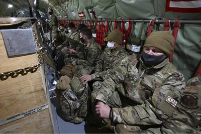Guardsmen are seated on a KC-135 Stratotanker from the Alaska Air National Guard's 168th Wing as they prepare to depart from Joint Base Elmendorf-Richardson, Alaska, Sunday, Jan. 17, 2021, to assist with the Jan. 20 inauguration of President-elect Joe Biden in Washington. (Bill Roth/Anchorage Daily News via AP)