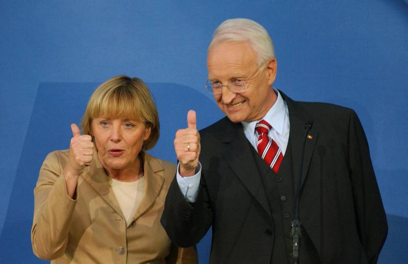 Edmund Stoiber, then CDU-CSU chancellor candidate, and Angela Merkel, CDU president, celebrate that their coalition is leading in the first returns in the general election at CDU headquarters in Berlin. September 22, 2002. AFP