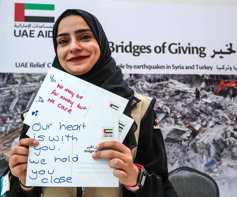 Volunteer, Muneera Al Hosani with postcards of encouragement