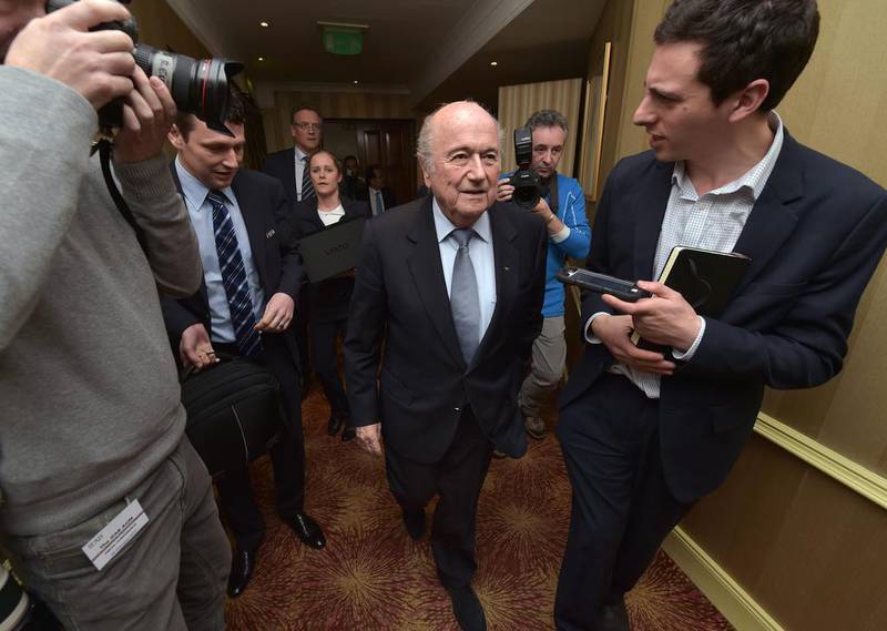 Fifa president Sepp Blatter, centre, exits the meeting to face questions from reporters at the International Football Association Board AGM at the Culloden Hotel on February 28, 2015 in Belfast, Northern Ireland.  (Photo by Charles McQuillan/Getty Images)