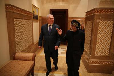 Sultan Qaboos walks with Mr. Netanyahu in Muscat. Reuters