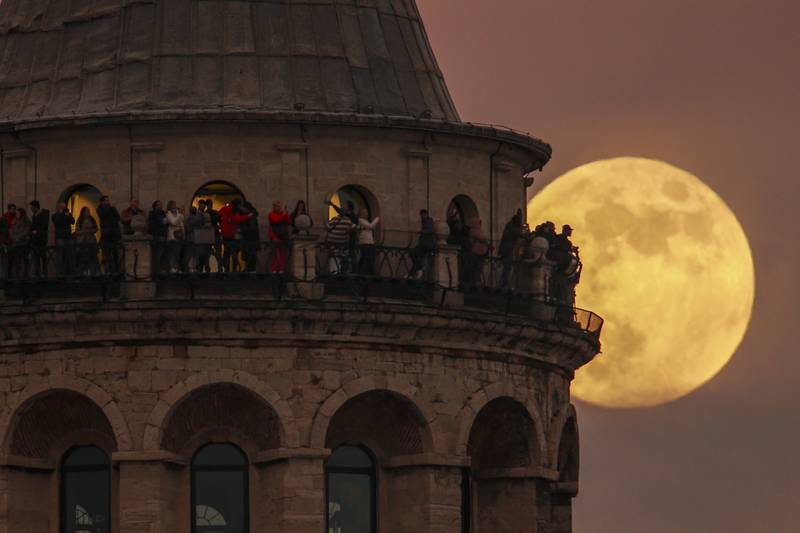The last full moon of the year known as the Cold Moon rises behind Galata tower in Istanbul, Turkey, Wednesday, Dec.  7, 2022.  (AP Photo / Emrah Gurel)