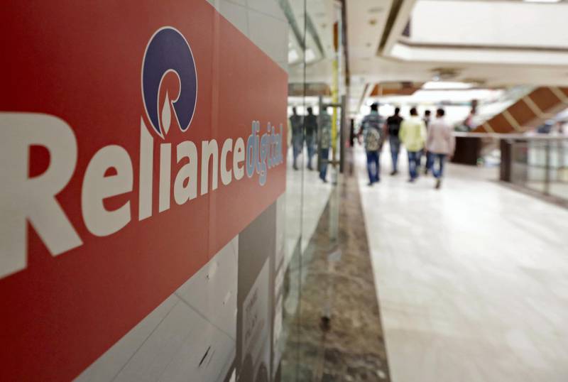 Signage for Reliance Digital, a subsidiary of Reliance Industries Ltd., is displayed outside a Reliance Digital store in New Delhi, India, on Monday, Sept. 5, 2016. Reliance Industries today launched their Jio mobile phone service in India, which will offer free voice calling to customers in the world’s second-largest smartphone market, as part of their plan to diversify from the oil and petrochemicals that comprised 95 percent of profit last year. Photographer: Anindito Mukherjee/Bloomberg