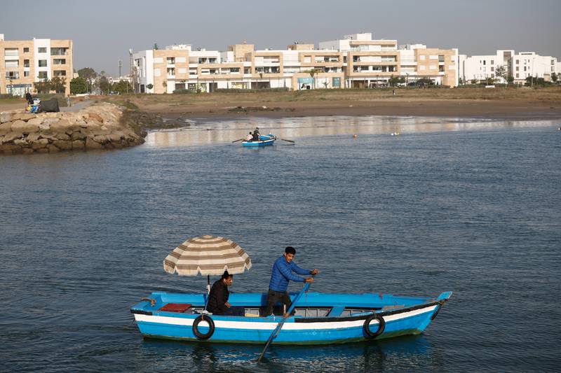 Small blue wooden boats have been transporting people between the banks of Bou Regreg river in Morocco for generations. All photos: Reuters