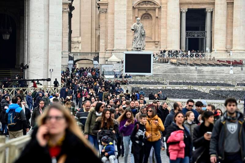 The faithful leave St Peter's Basilica after paying their respects to the late Pope Emeritus Benedict XVI. EPA