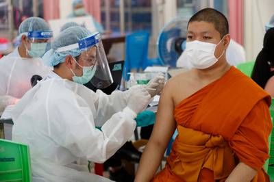 A health worker injects a Buddhist monk with dose of the Sinovac COVID-19 vaccine in Bangkok, Thailand. AP Photo