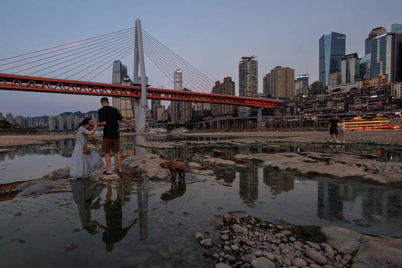 People walk on the partially dried-up riverbed of China's Jialing river, a tributary of the Yangtze, that is approaching record low water levels. Reuters