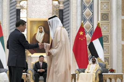 ABU DHABI, UNITED ARAB EMIRATES - July 20, 2018:  HE Dr Sultan Ahmed Al Jaber, UAE Minister of State, Chairman of Masdar and CEO of ADNOC Group (R), exchanges an MOU with a member of the Chinese delegation, at the Presidential Palace. Witnessed by HH Sheikh Mohamed bin Rashid Al Maktoum, Vice-President, Prime Minister of the UAE, Ruler of Dubai and Minister of Defence (back R) and HE Xi Jinping, President of China (back L),

( Mohamed Al Hammadi / Crown Prince Court - Abu Dhabi )
---