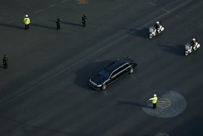 A Mercedes limousine with a golden emblem, similar to one Kim Jong-un has used previously, is escorted by motorcades travelling past Chang'an Avenue in Beijing. AP Photo