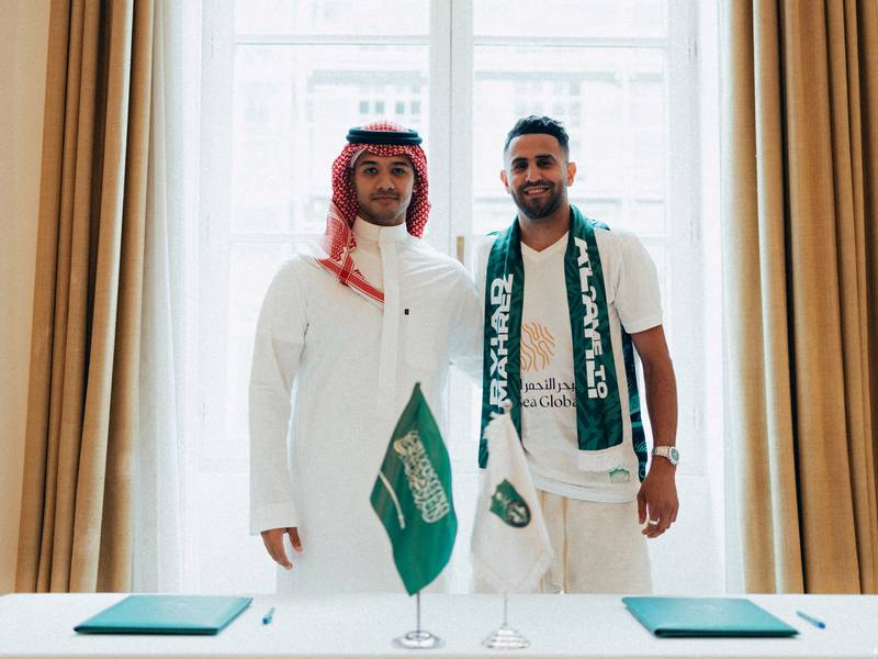 Al Ahli's new signing Riyad Mahrez with the club's executive director Yazin Al Sharif Al-Ahli. Reuters