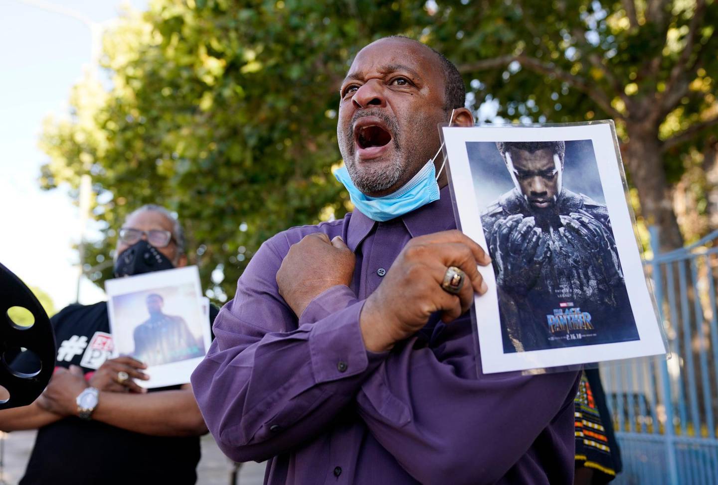 Najee Ali, director of Project Islamic Hope, leads a "Wakanda Forever!" salute from the 2018 film "Black Panther," during a news conference to celebrate the late actor and "Black Panther" star Chadwick Boseman, Saturday, Aug. 29. 2020, in Los Angeles. Boseman died Friday at 43 after a four-year fight with colon cancer. (AP Photo/Chris Pizzello)