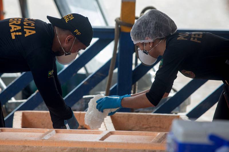 Federal Police forensics officers examine a boat seized by the task force sent to rescue of missing indigenous expert Bruno Pereira and British journalist Dom Phillips at the port of the city of Atalaia do Norte, Amazonas, Brazil. On Friday, authorities say they found ‘apparently human’ material. AFP