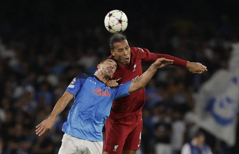 Liverpool's Virgil van Dijk takes on Napoli's Giovanni Simeone in the Champions League. Reuters