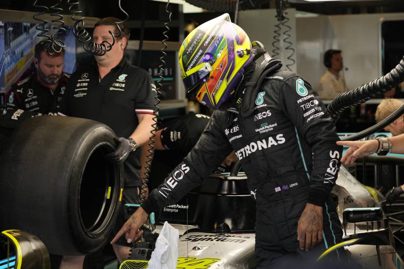 Mercedes driver Lewis Hamilton of Britain talks to mechanics during practice. AP Photo 