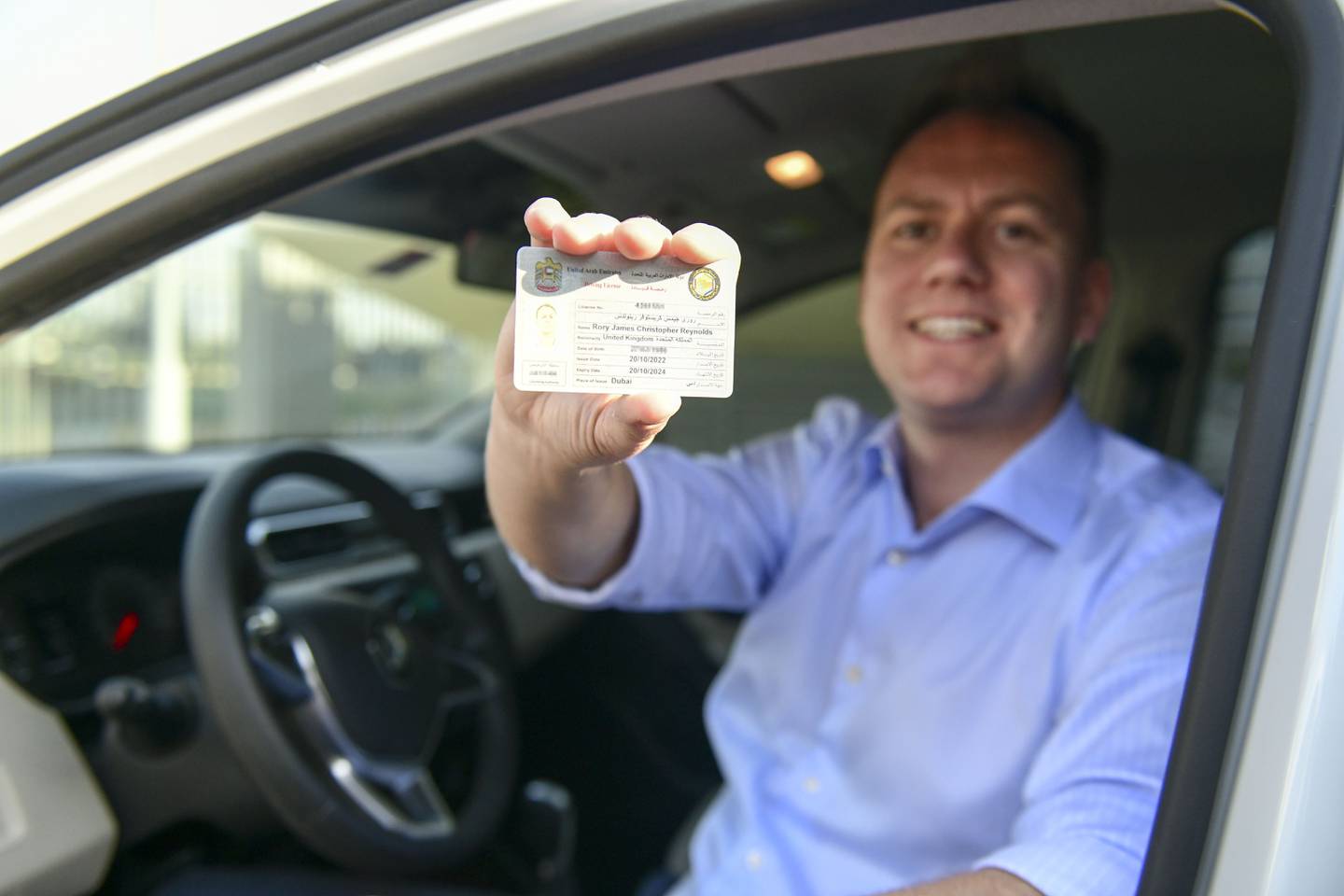 Rory with his UAE driving licence after passing in Dubai. Khushnum Bhandari / The National