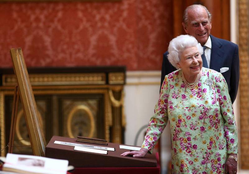 Queen Elizabeth II and Prince Philip, Duke of Edinburgh, stand next to a display of Spanish items from the Royal Collection during the state visit of Spanish King Felipe VI and Queen Letizia at Buckingham Palace in central London on July 12, 2017. Neil Hall.