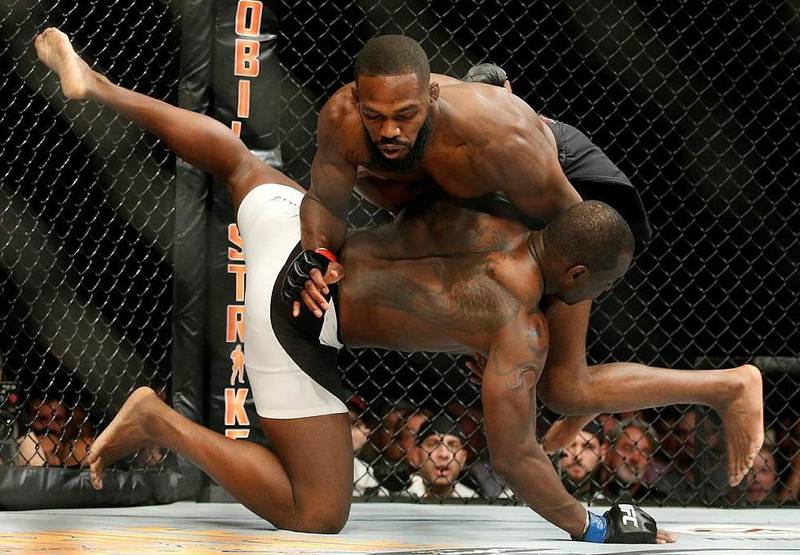 Jon Jones, top, has indicated his next fight will be at heavyweight, but the American has been embroiled in a Twitter feud with middleweight champion Israel Adesanya. AP Photo