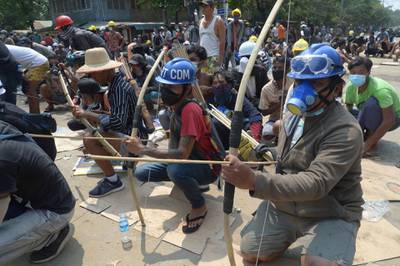 Protesters prepare makeshift bow and arrows to confront police in Thaketa township Yangon. AP Photo