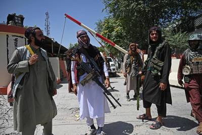 Taliban fighters stand guard along a roadside near the Zanbaq Square in Kabul. AFP