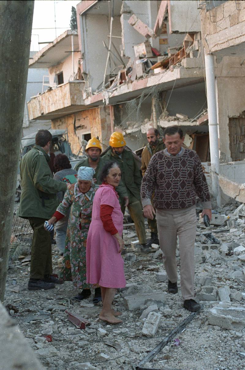 Two elderly Israeli women look at damage caused when an Iraqi Scud missile slammed into their house January 18, 1991. Reuters