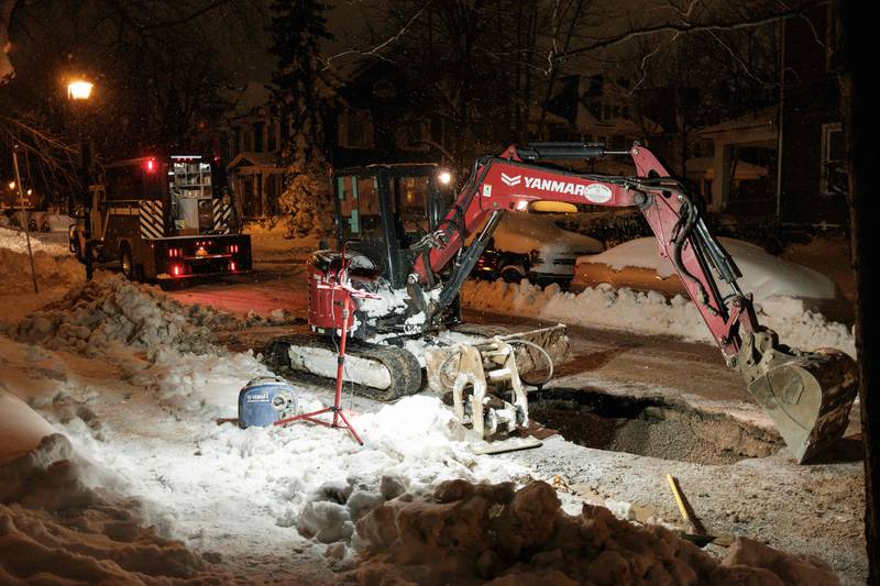 An excavator is used to repair a water main. AFP