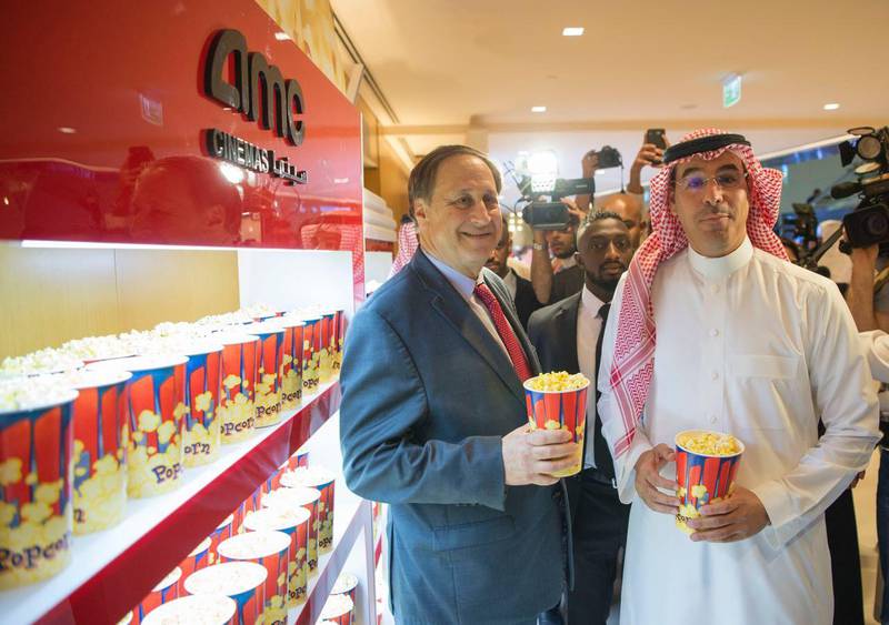 epa06677903 A handout photo made available by the Saudi Ministry of Culture and Information's Center for International Communication shows Adam Aron (L), CEO of AMC Entertainment, and Saudi Minister of Culture and Information Awwad Alawwad (R) grab two popcorn buckets at the inauguration of the Kingdom’s first public cinema at King Abdullah Financial District (KAFD) theatre in Riyadh, Saudi Arabia, 18 April 2018. The launch event included the first public screening of a commercial film in more than 35 years in Saudi Arabia - the Hollywood blockbuster Black Panther.  EPA/SAUDI MINISTRY OF CULTURE / HANDOUT  HANDOUT EDITORIAL USE ONLY/NO SALES