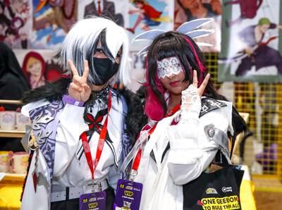 Diana, left, dressed as Arlecchino and Nona, right, as Columbina. Both are characters from Genshin Impact