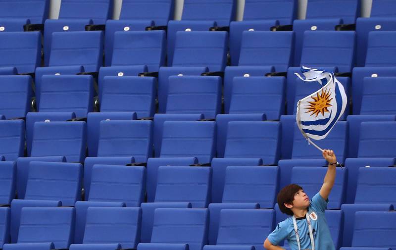 A boy holds the Uruguayan flag before the match between Russia and Uruguay on Samara stadium, Russia, on June 25, 2018. Pilar Olivares / Reuters
