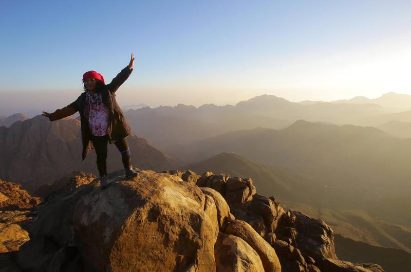 A tourist poses for a photo on the top of Mount Sinai. EPA