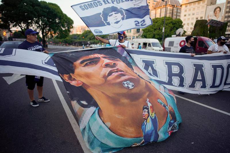 Ffans carry a banner of Maradona in downtown Buenos Aires. AP