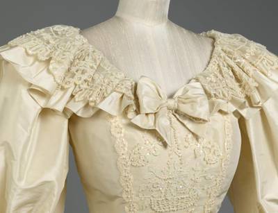 A detailed view of the neckline of the wedding dress. Royal Collection Trust