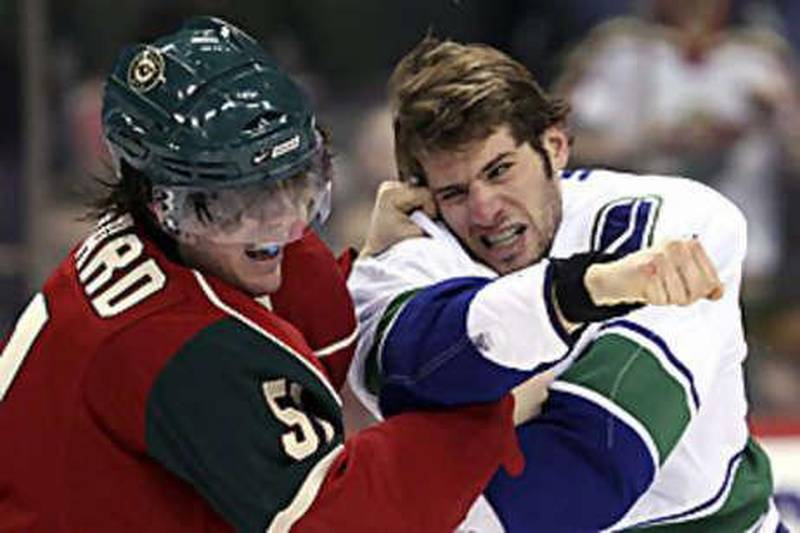 The Vancouver Canucks centre Ryan Kesler, right, swings at the Minnesota Wild centre James Sheppard during Vancouver's narrow win.