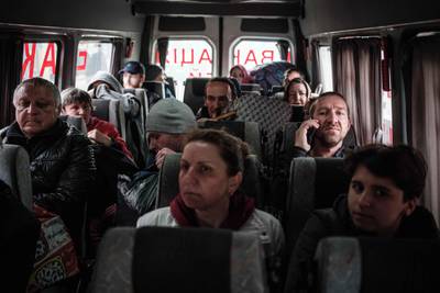 Evacuees from the eastern Ukraine city of Lyman, which has suffered heavy shelling, ride on a bus in Raihorodok. AFP
