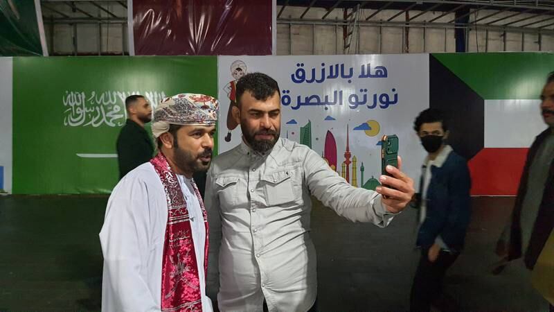 Al Hashemi poses for a selfie with an Iraqi citizen at Basra Corniche. Sinan Mahmoud / The National.