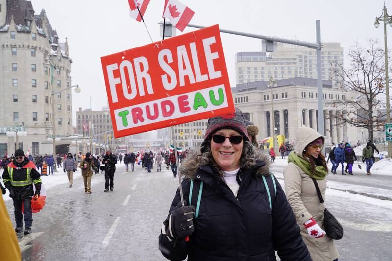 A woman carries a sign that says "For Sale: Trudeau." Willy Lowry / The National.