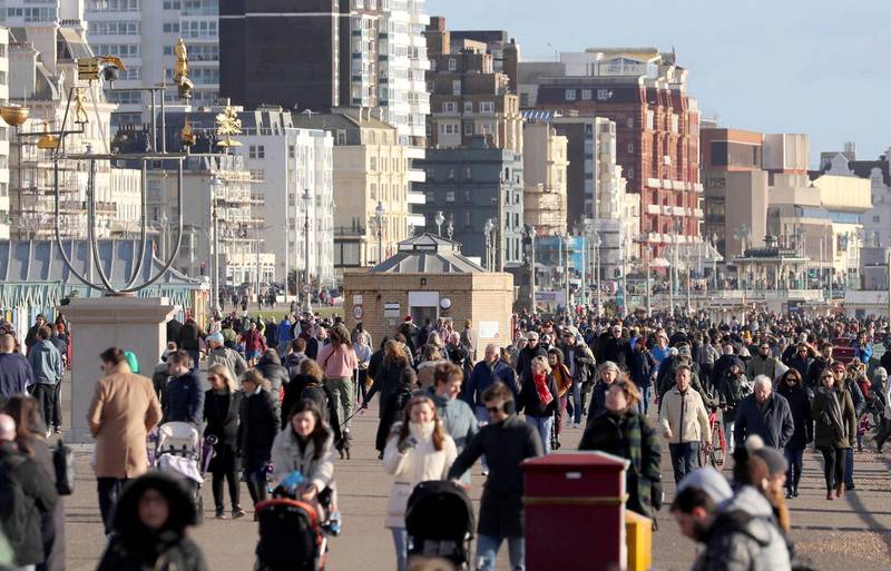 People walk on the sea front in Brighton. AP Photo