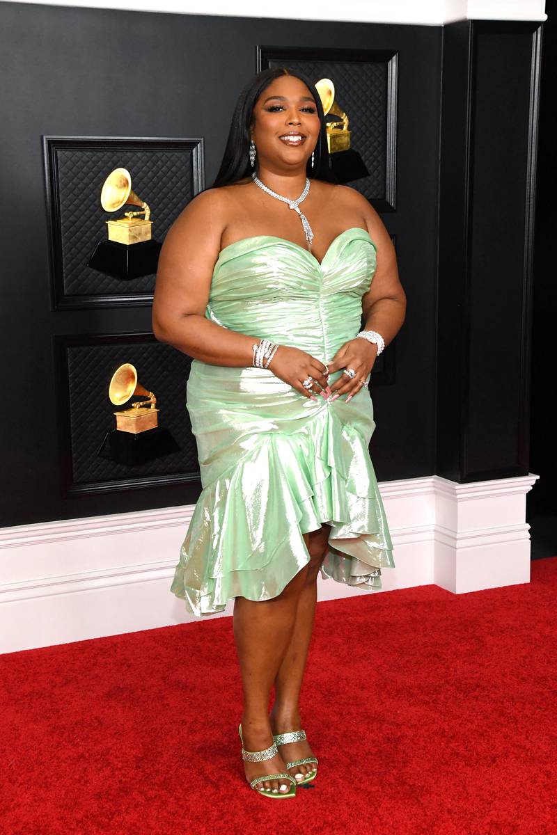 Lizzo also wears a green Balman dress at the Grammy Awards on March 14, 2021. AFP