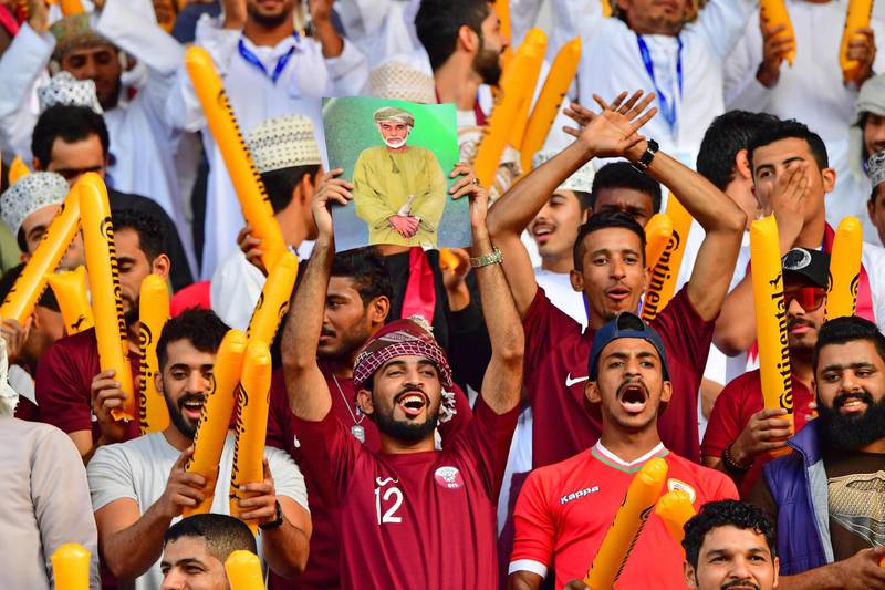Football fans don Qatar football shirts at the final against Japan on February 1 in Abu Dhabi. Giuseppe Cacace / AFP