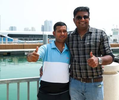 Ferry passengers George Mathew and Nikhil SP at the Sharjah Corniche ferry station wait for the boat to arrive from Dubai. All photos: Victor Besa / The National