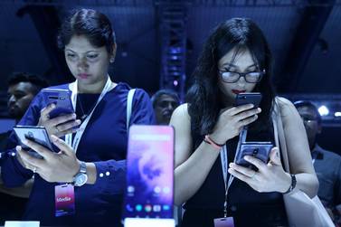 Visitors checking the new phones of OnePlus 7 series in Bangalore on Tuesday. EPA