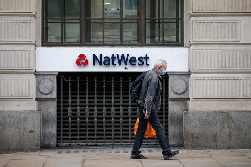 A pedestrian, wearing a protective face mask, passes a bank branch of Natwest, operated by National Westminster Bank Plc, in London, U.K. U.K. Prime Minister Boris Johnson's government is considering tougher action to fight the spread of the coronavirus in London but has denied it is planning to confine residents to their homes or seal off the city. Bloomberg