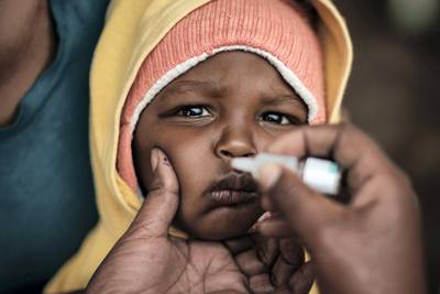 A child is vaccinated during a launching ceremony of the five-day polio vaccineation campaign in high risk counties, targeting about two million children under five years old, in Kajiado, Kenya, on July 11, 2018. (Photo by Yasuyoshi CHIBA / AFP)