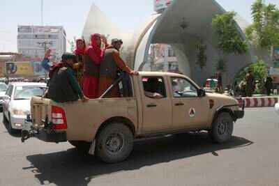 Taliban fighters travel in an Afghan Army vehicle in Herat.
