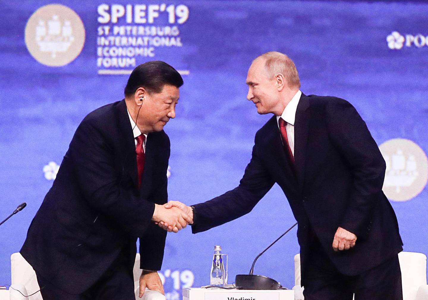 Russian President Vladimir Putin, right, shakes hands with Chinese President Xi Jinping at the St. Petersburg International Economic Forum in St. Petersburg, Russia, Friday, June 7, 2019. (Mikhail Metzel/TASS News Agency Pool Photo via AP)