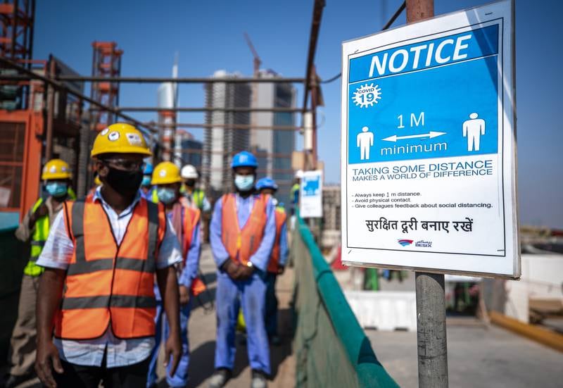 A notice reminding workers of Covid-19 precautions on the site.
